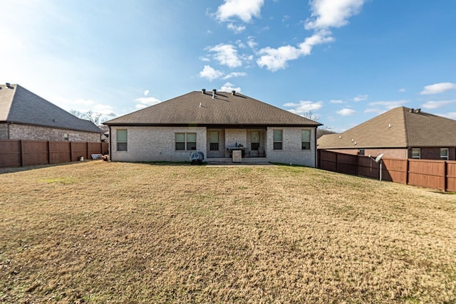 back of property with a patio area and a yard