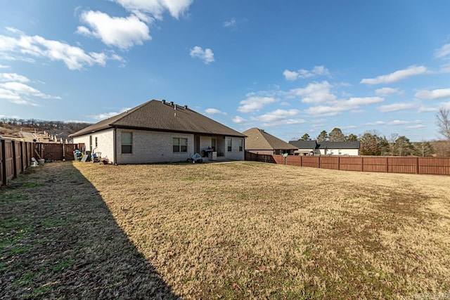 rear view of property featuring a yard