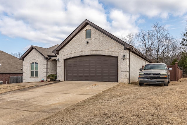 french country style house featuring a garage