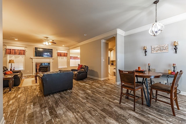 dining room with ceiling fan, dark hardwood / wood-style flooring, and ornamental molding