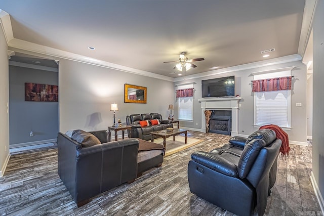 living room featuring ceiling fan, dark hardwood / wood-style floors, and ornamental molding