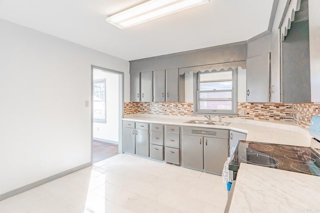 kitchen featuring decorative backsplash, sink, electric range, and gray cabinets