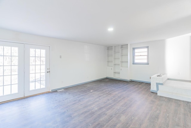 spare room featuring a wealth of natural light and wood-type flooring