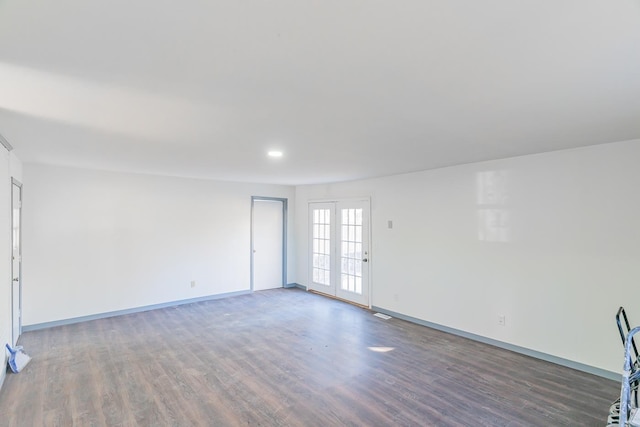 unfurnished room featuring dark hardwood / wood-style flooring and french doors