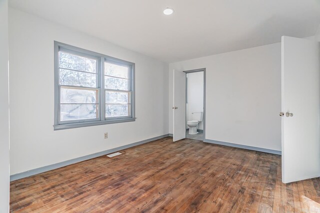 unfurnished room with dark hardwood / wood-style flooring