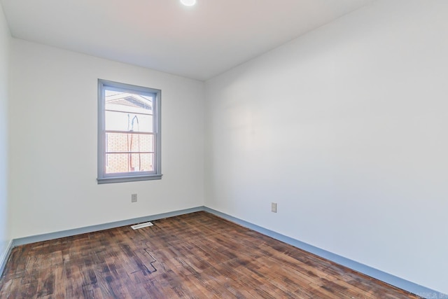 spare room with dark hardwood / wood-style floors