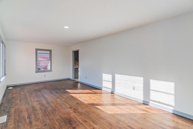 spare room featuring wood-type flooring