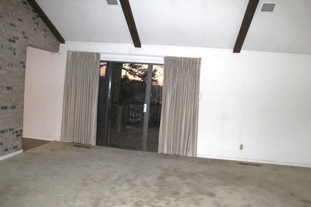 empty room featuring vaulted ceiling with beams and carpet floors