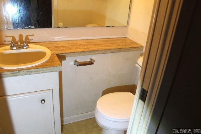 bathroom featuring toilet and vanity