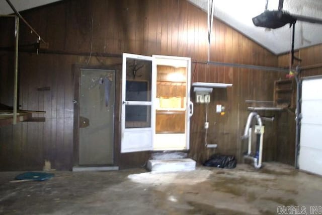 garage featuring wood walls