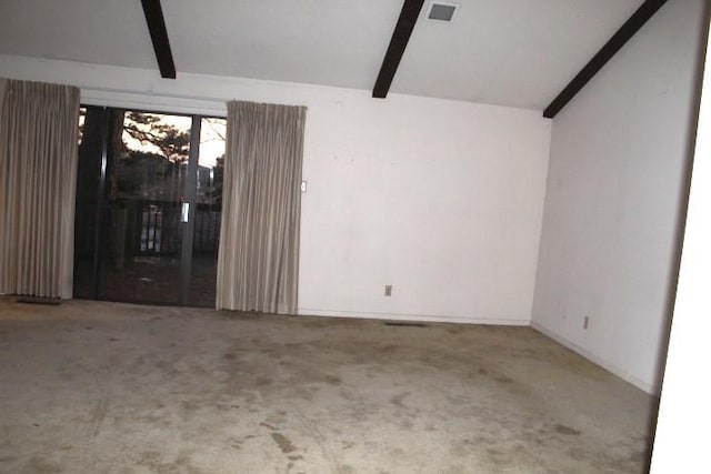 carpeted spare room featuring lofted ceiling with beams