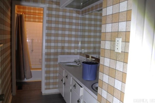 bathroom featuring vanity and shower / bathtub combination with curtain