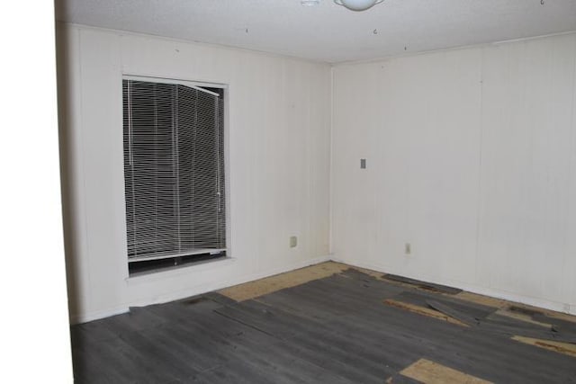 unfurnished room featuring dark hardwood / wood-style flooring