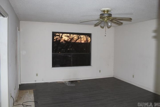 spare room featuring ceiling fan, a textured ceiling, and dark hardwood / wood-style floors