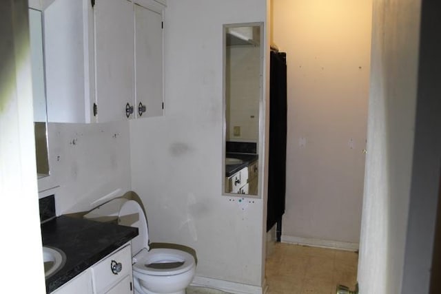 bathroom featuring toilet and vanity