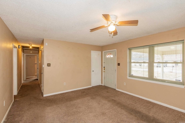 unfurnished room featuring ceiling fan, a textured ceiling, and carpet flooring