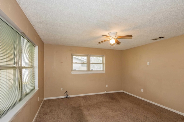 unfurnished room featuring ceiling fan, carpet, and a textured ceiling