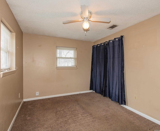 unfurnished room with carpet floors, a textured ceiling, and ceiling fan