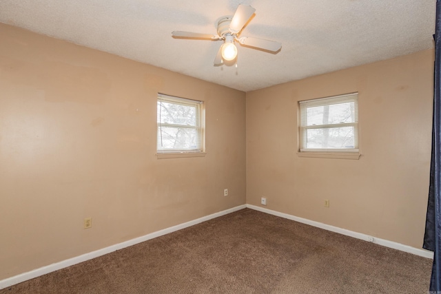 spare room with ceiling fan, carpet, and a healthy amount of sunlight