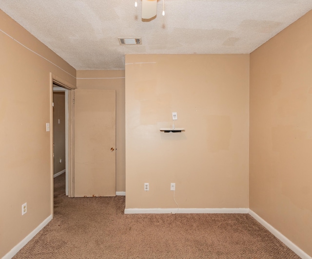 unfurnished room featuring ceiling fan, carpet floors, and a textured ceiling