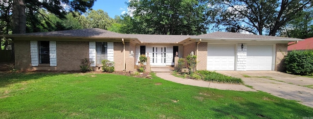 single story home with a garage and a front lawn