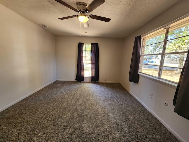 unfurnished room featuring ceiling fan, carpet flooring, and a textured ceiling