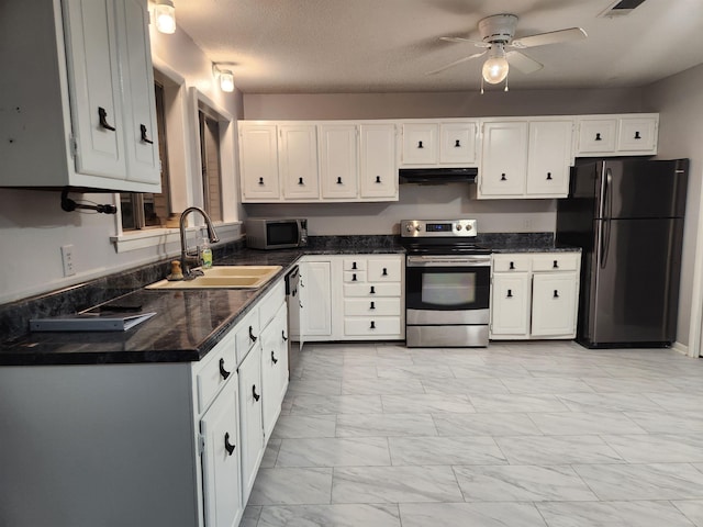 kitchen featuring sink, white cabinetry, a textured ceiling, appliances with stainless steel finishes, and ceiling fan