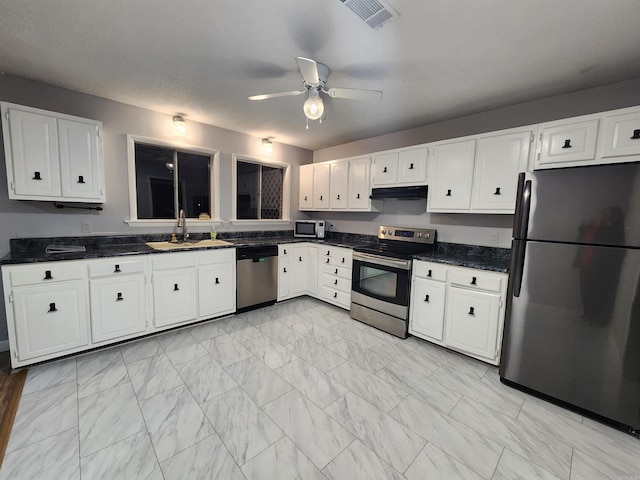 kitchen featuring stainless steel appliances, white cabinetry, and sink