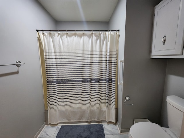 bathroom with toilet and walk in shower