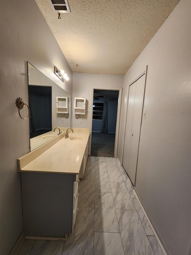 bathroom featuring vanity and a textured ceiling