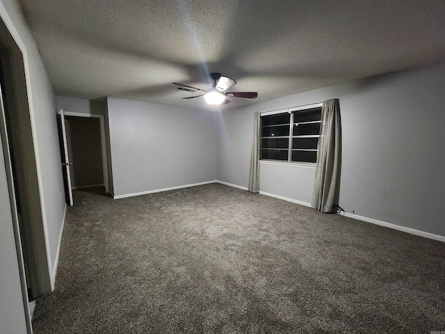 unfurnished bedroom with dark colored carpet, a textured ceiling, and ceiling fan