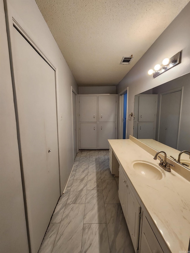 bathroom featuring vanity and a textured ceiling