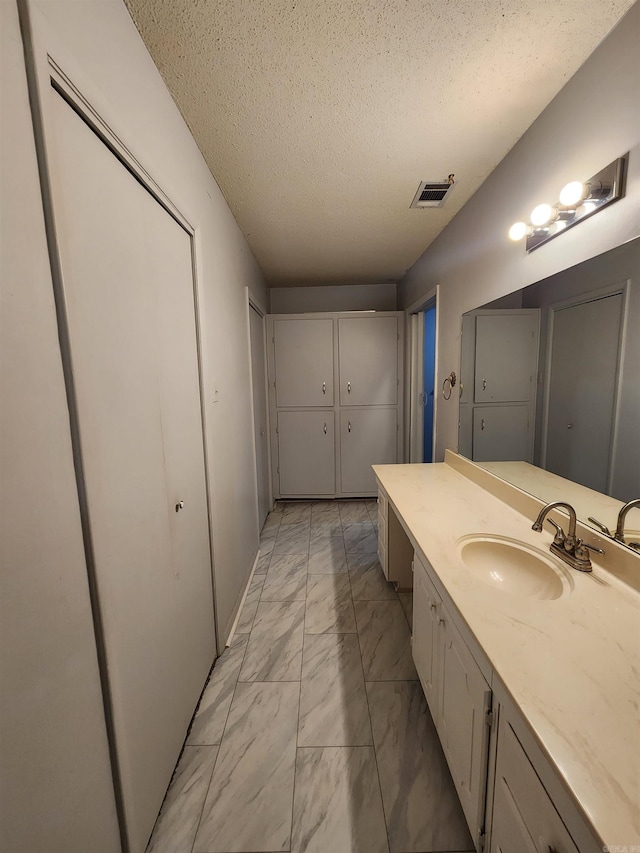 bathroom featuring vanity and a textured ceiling