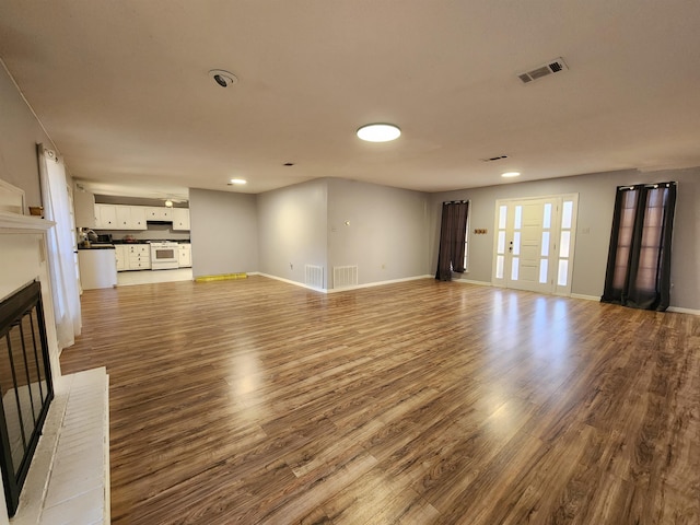 unfurnished living room with a fireplace and hardwood / wood-style floors