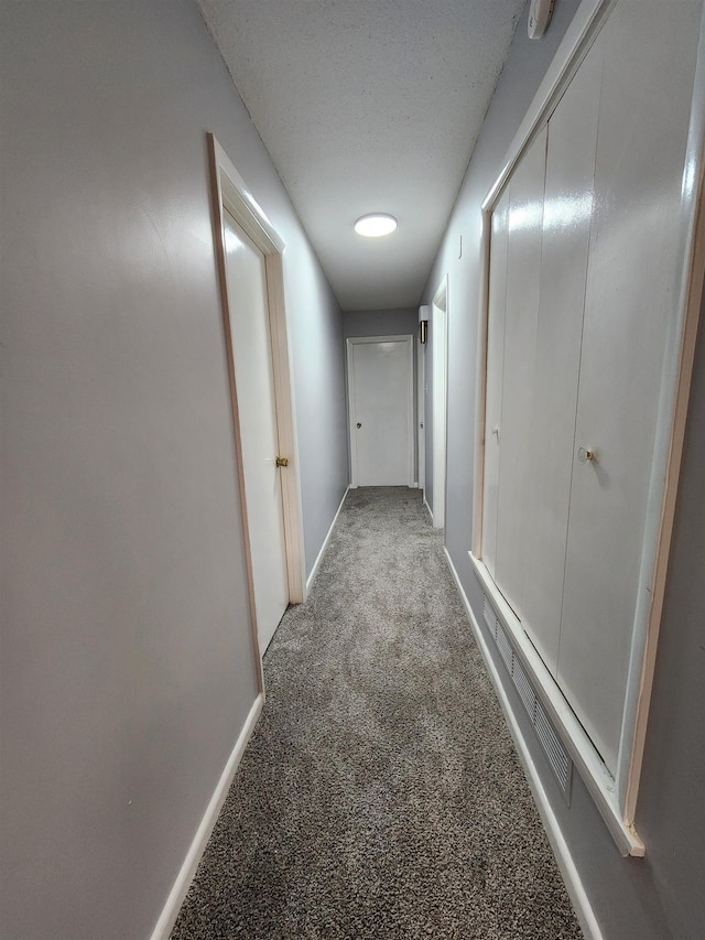 hallway with light colored carpet