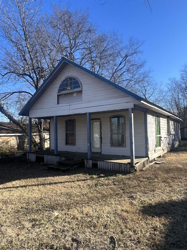 view of front of home with a front yard and a porch