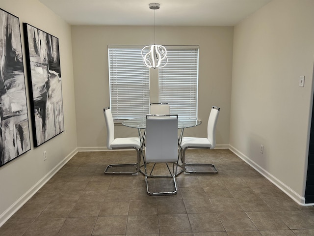 tiled dining space featuring an inviting chandelier