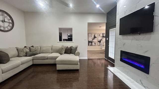 living room featuring a premium fireplace and hardwood / wood-style flooring