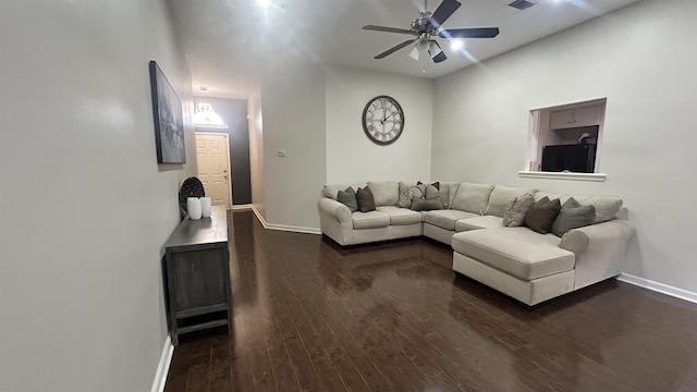 living room featuring ceiling fan and dark hardwood / wood-style floors