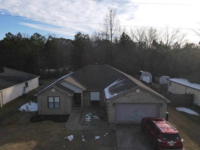 view of front of home featuring brick siding and driveway