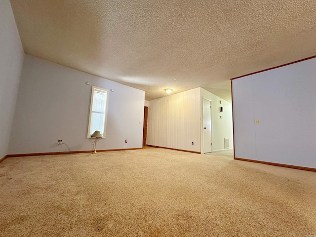 carpeted empty room with a textured ceiling