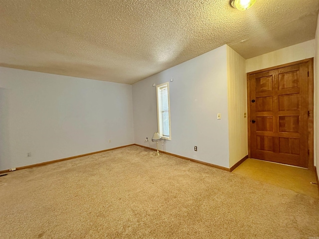 interior space with light carpet and a textured ceiling