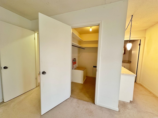 hallway featuring light colored carpet