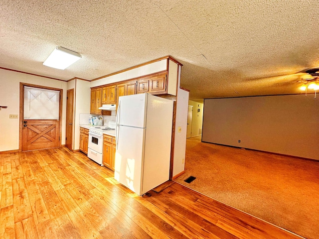 kitchen with light wood-type flooring, white appliances, and ornamental molding