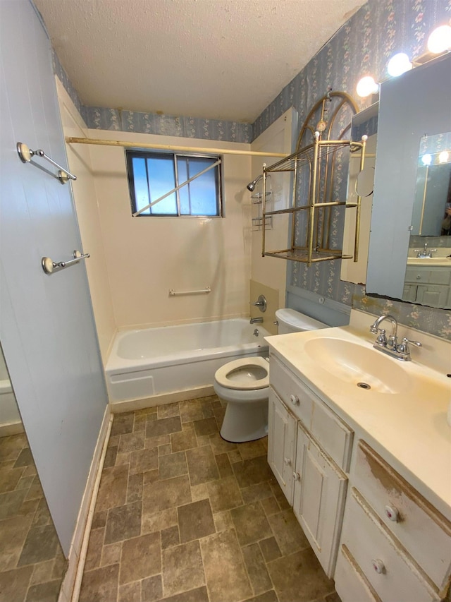 full bathroom with a textured ceiling, toilet, vanity, and  shower combination