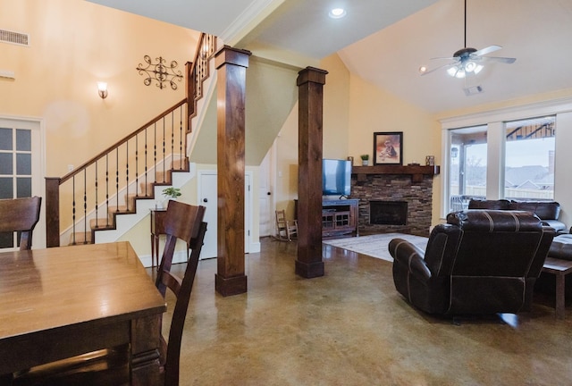 living room featuring ceiling fan, high vaulted ceiling, decorative columns, and a fireplace