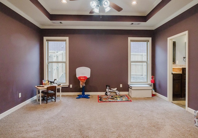 rec room with carpet floors, a wealth of natural light, and a raised ceiling