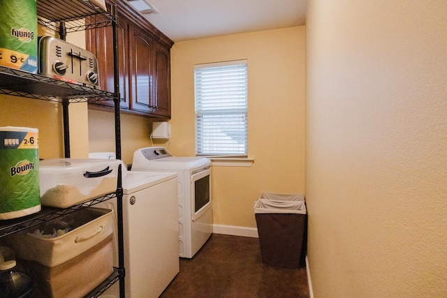 laundry room featuring cabinets and separate washer and dryer