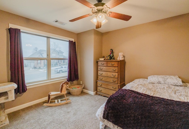 carpeted bedroom with ceiling fan and multiple windows