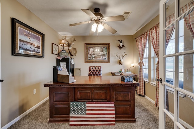 carpeted office space with ceiling fan and french doors